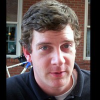 Dudley Brinkman Blue-eyed man with short dark hair